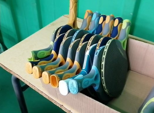 Raquettes de ping-pong alignées sur une boîte en carton.